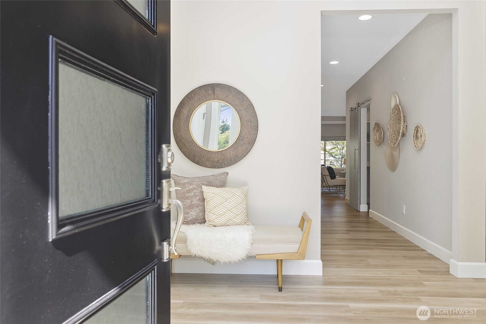 The impressive 12-foot entryway, adorned with a hand-forged chandelier, also offers the rare amenity of a double-sized closet, creating an unforgettable foyer.