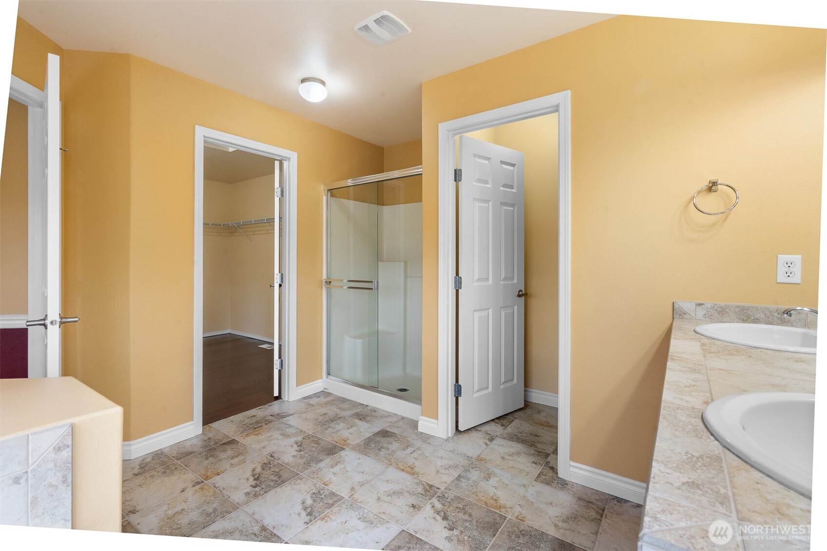 Glass shower, generous walk-in closet, and a layout designed for everyday comfort