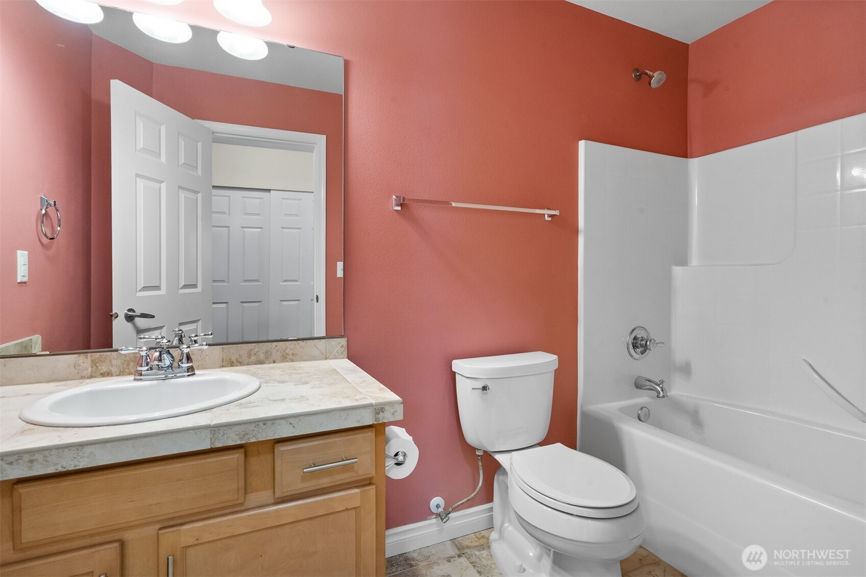 Well-appointed full bathroom with tub/shower and generous vanity storage