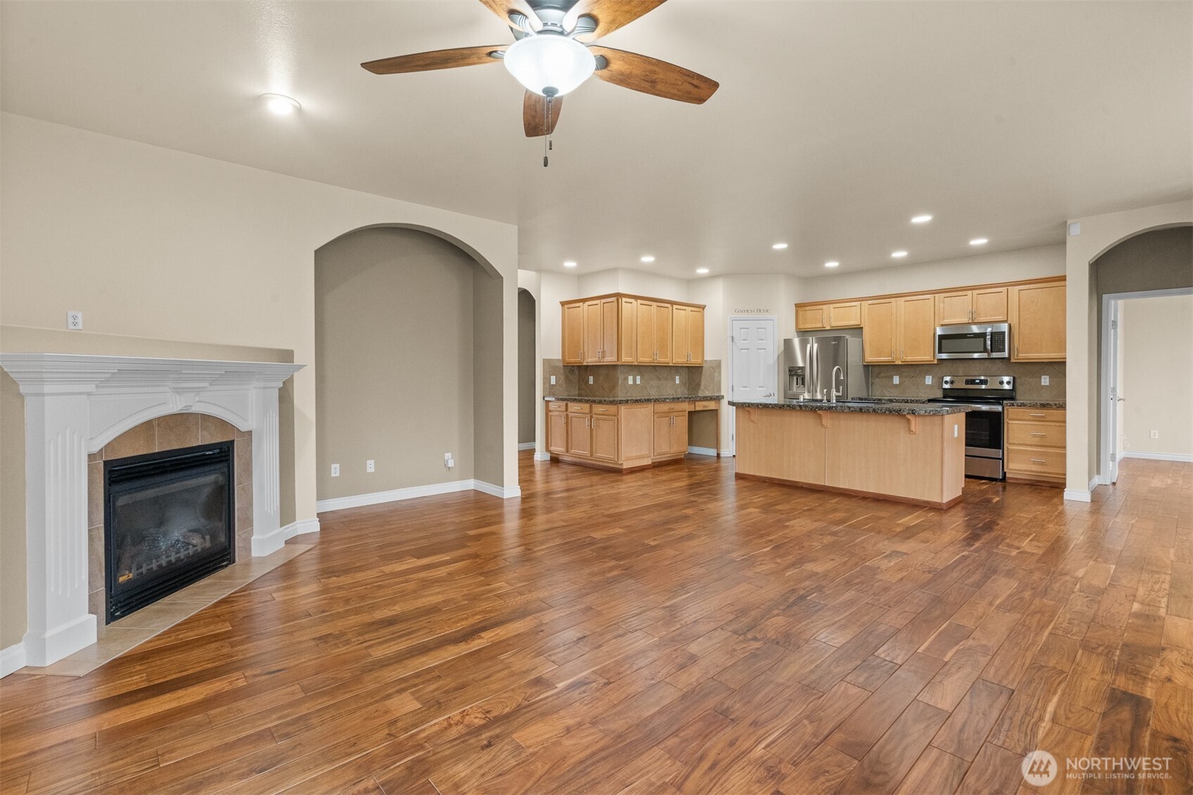 Rich Acacia hardwood floors flow throughout the open living space