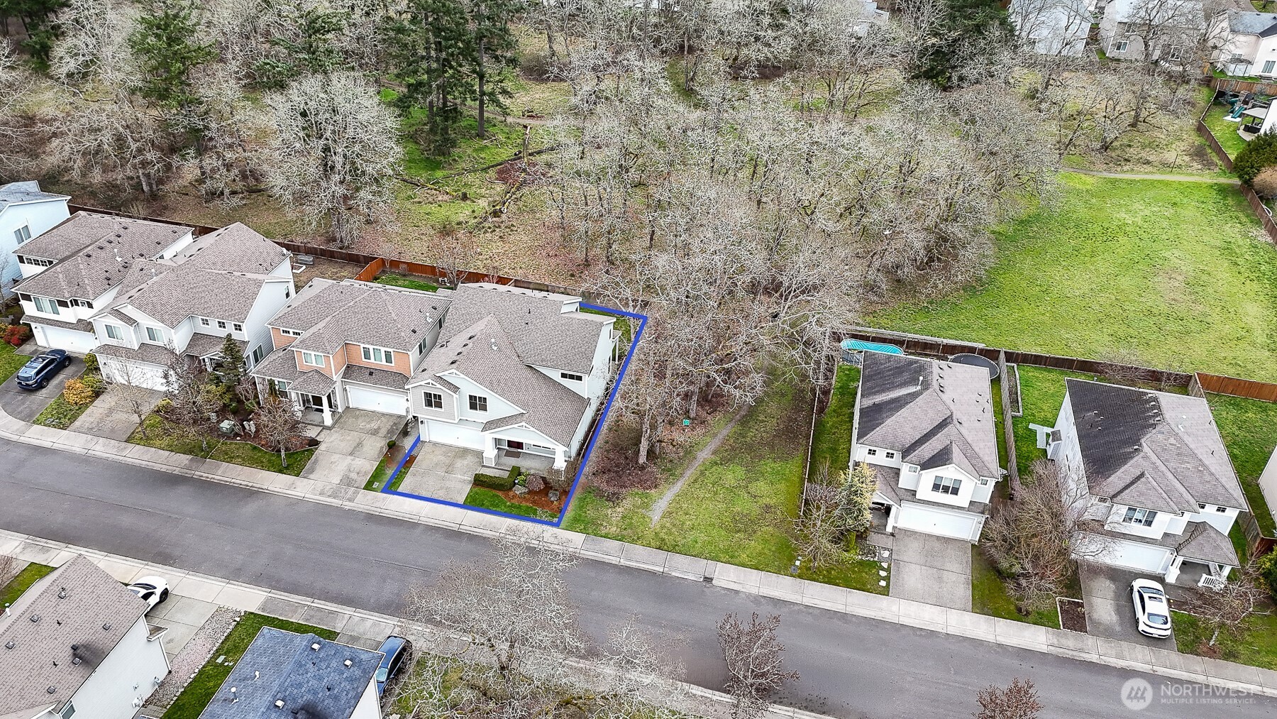 Tucked beside mature trees and open space, this home offers the rare balance of neighborhood living with a little extra breathing room