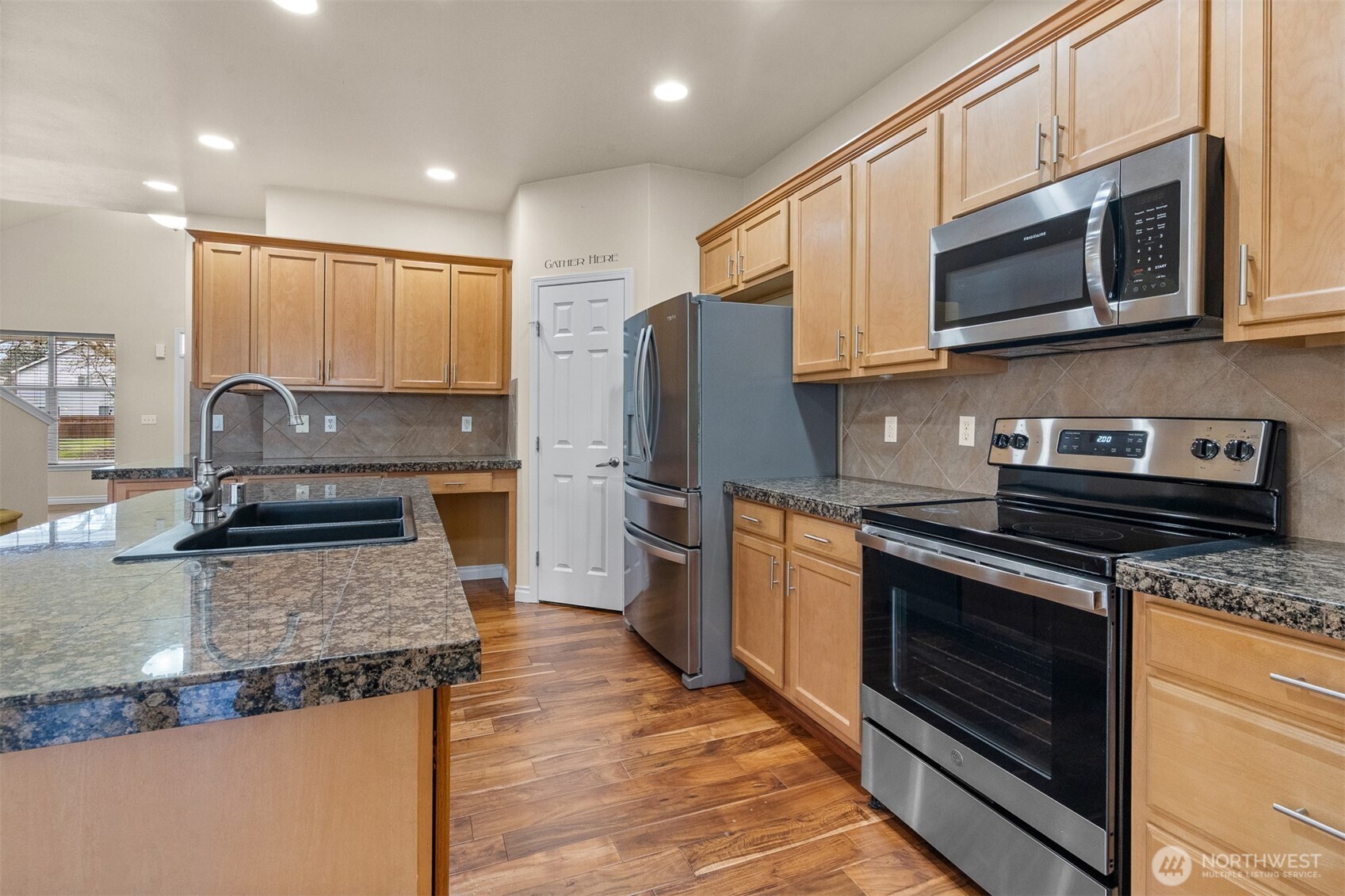 Granite surfaces, stainless finishes, and timeless details throughout