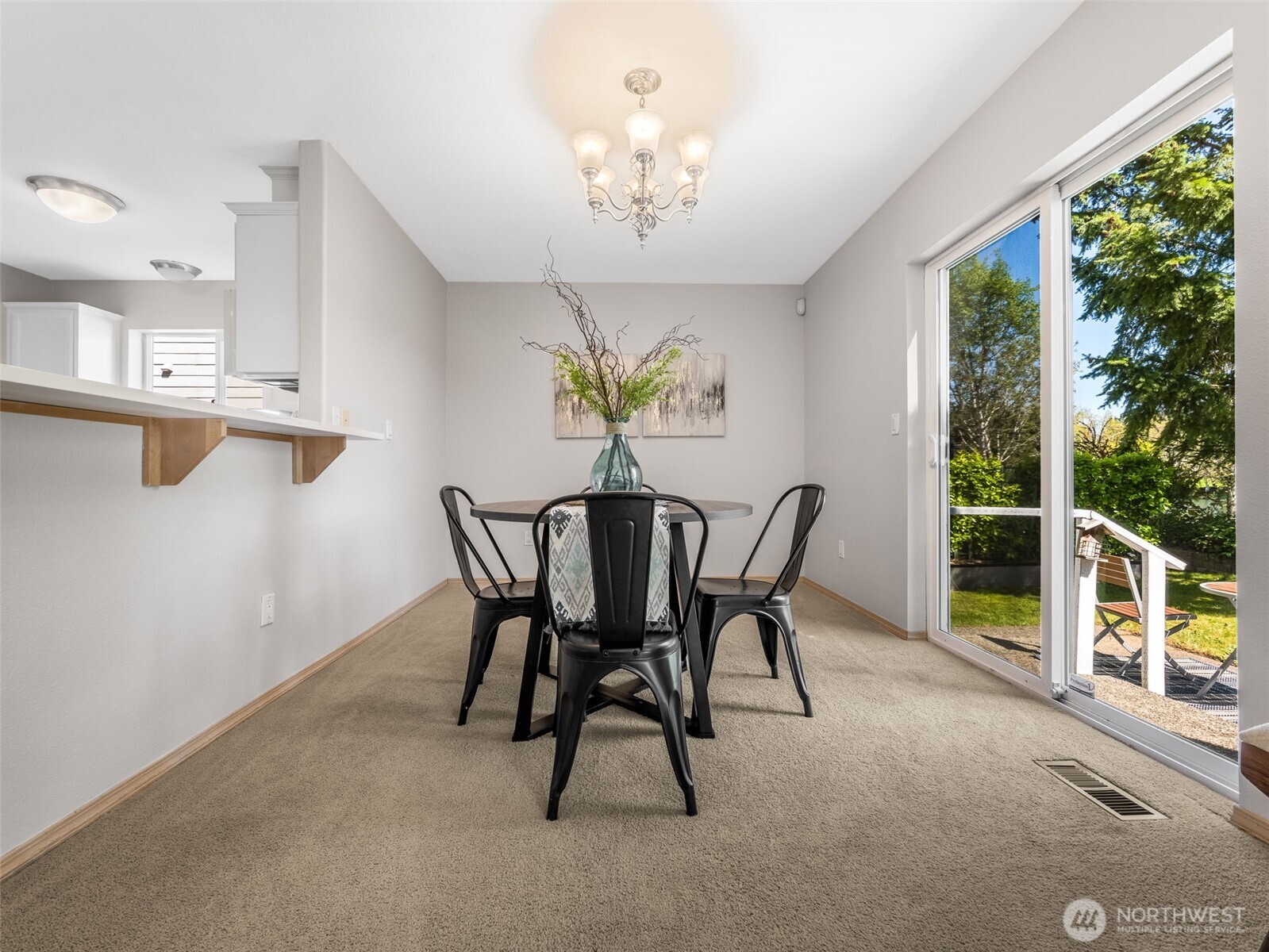 Adjacent to the kitchen is the formal dining area. You can see the slider to the right that leads out to the backyard.