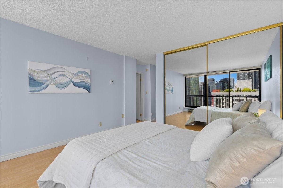 Floor-to-ceiling mirrors open up the primary suite, making it feel even more spacious and light-filled.