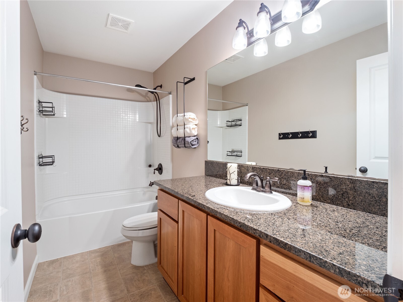 Functional and attractive bathroom with beautiful New Caledonia granite vanity.