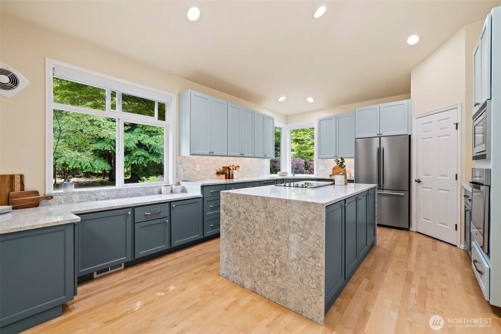 Beautifully remodeled kitchen with walk-in pantry, quartz countertops, plenty of cabinetry, stainless appliances and hardwood floors. This is a one story rambler; so you could add a hood vent over the range quite easily if desired.