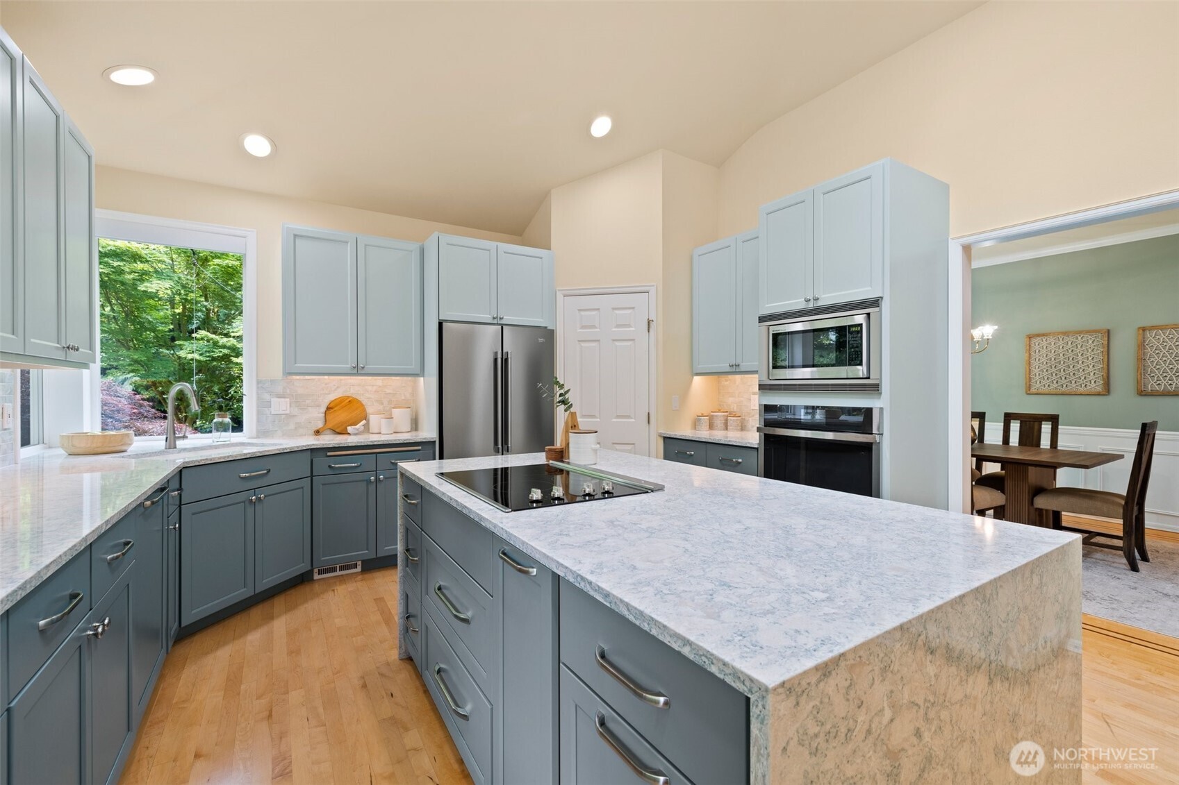 Beautifully remodeled kitchen with walk-in pantry, quartz countertops, plenty of cabinetry, stainless appliances and hardwood floors. This is a one story rambler; so you could add a hood vent over the range quite easily if desired.