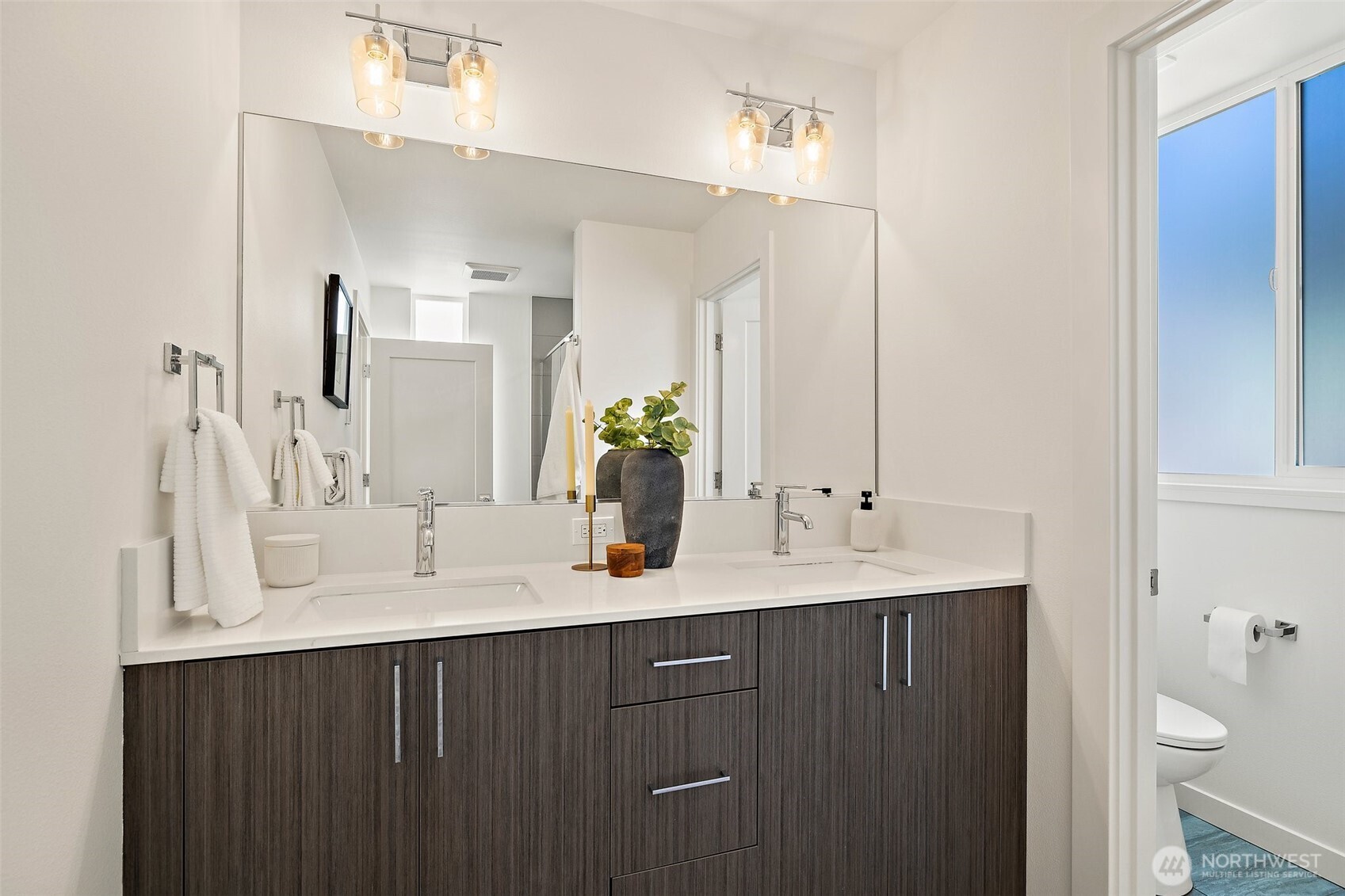 Primary bathroom dual vanity with private water closet.