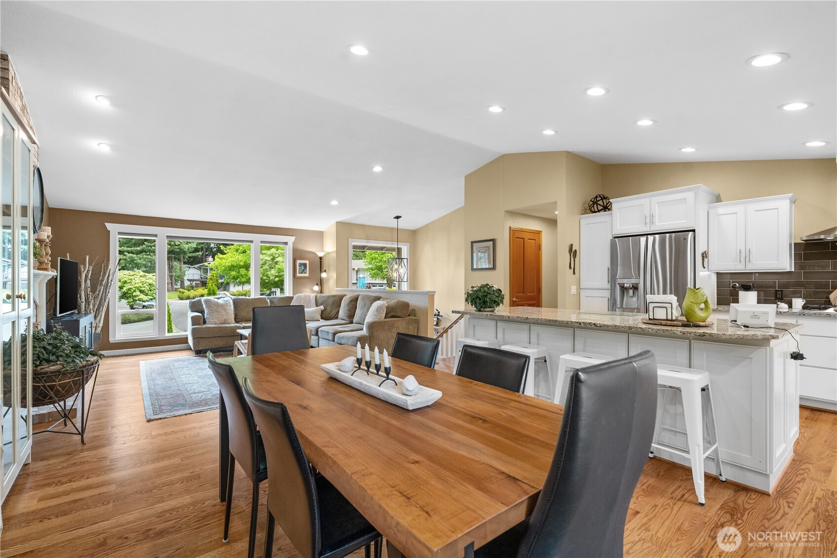 Beautiful oak hardwood flooring flows seamlessly throughout the common rooms blending the rooms harmoniously.