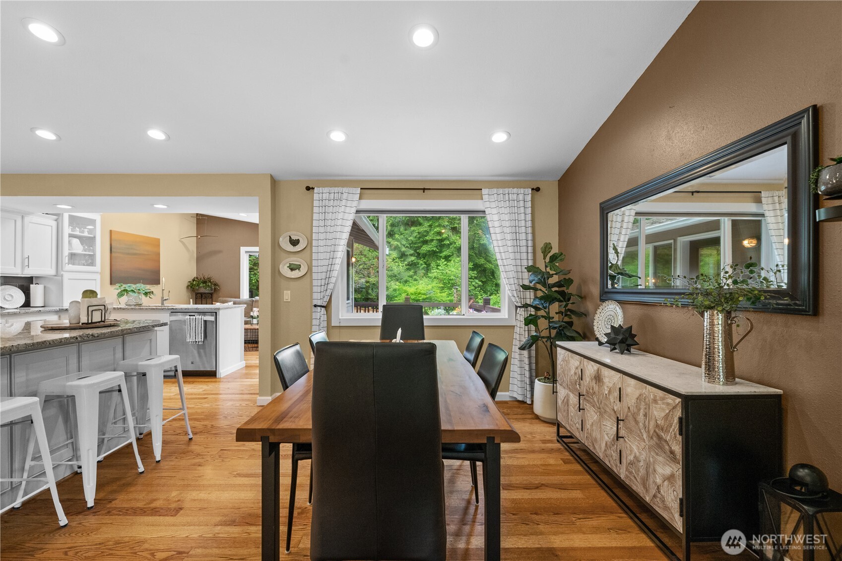 Additional island seating near the dining room offers a convenient option for overflow guests.
