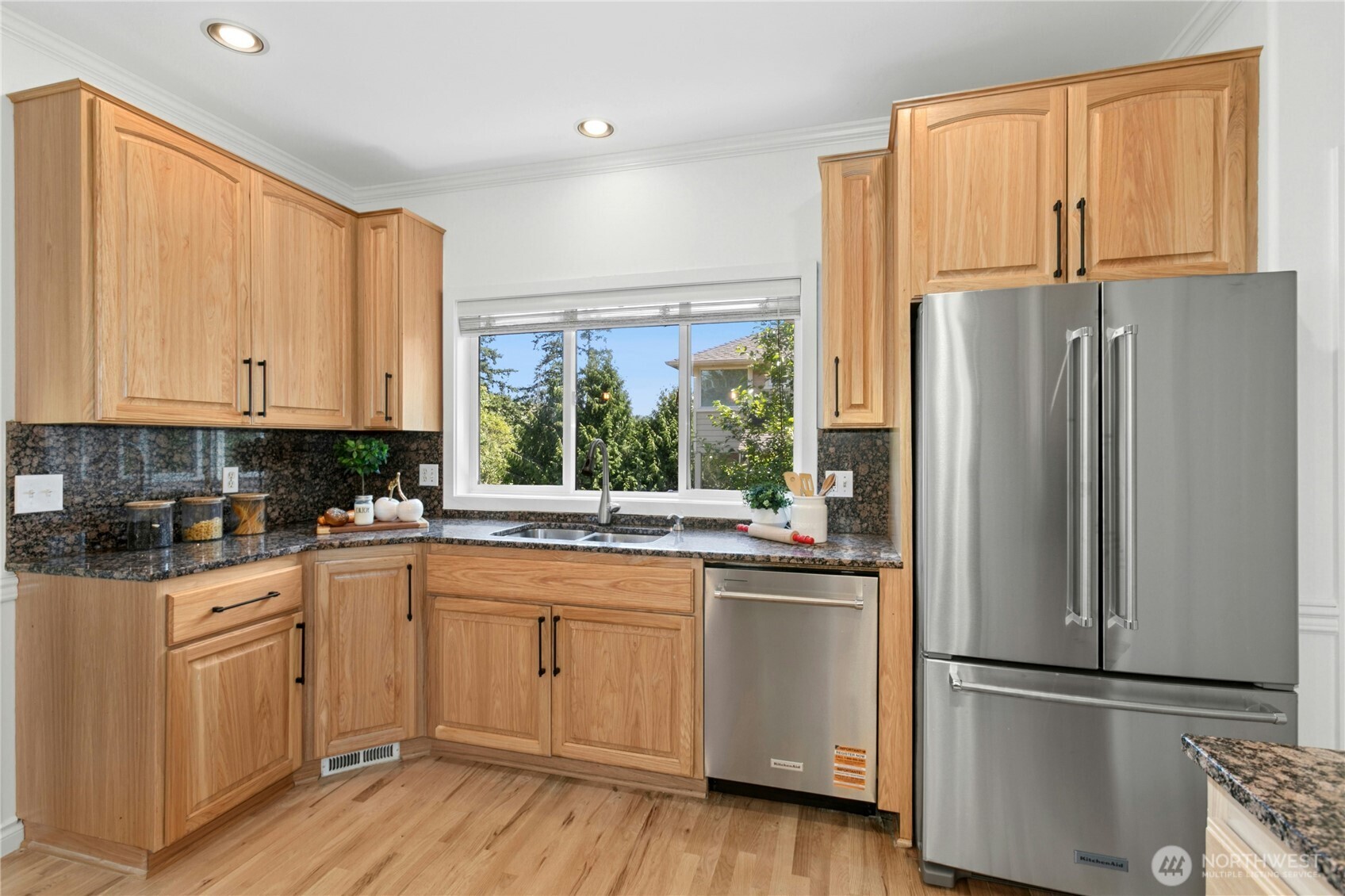 Island kitchen provides all new stainless steel appliances, granite countertops, and freshly refinished hardwood floors.