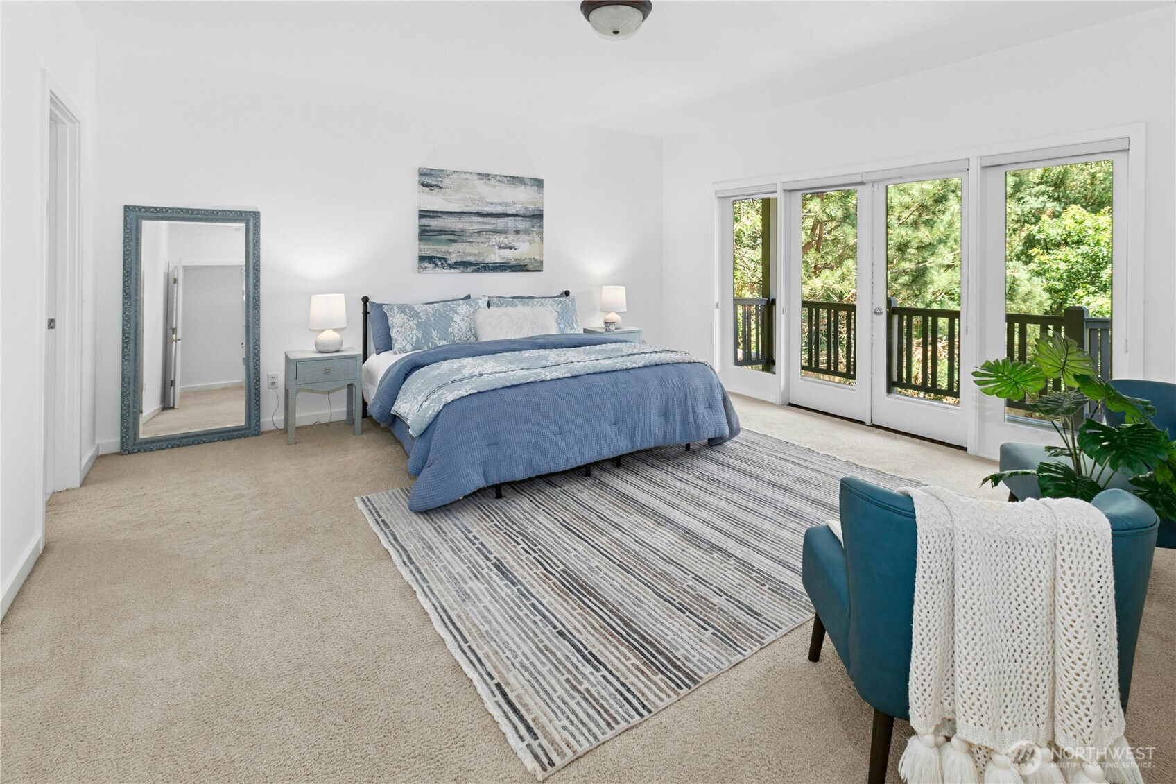 Main floor primary suite offers plenty of room for seating area to relax with coffee and a good book.