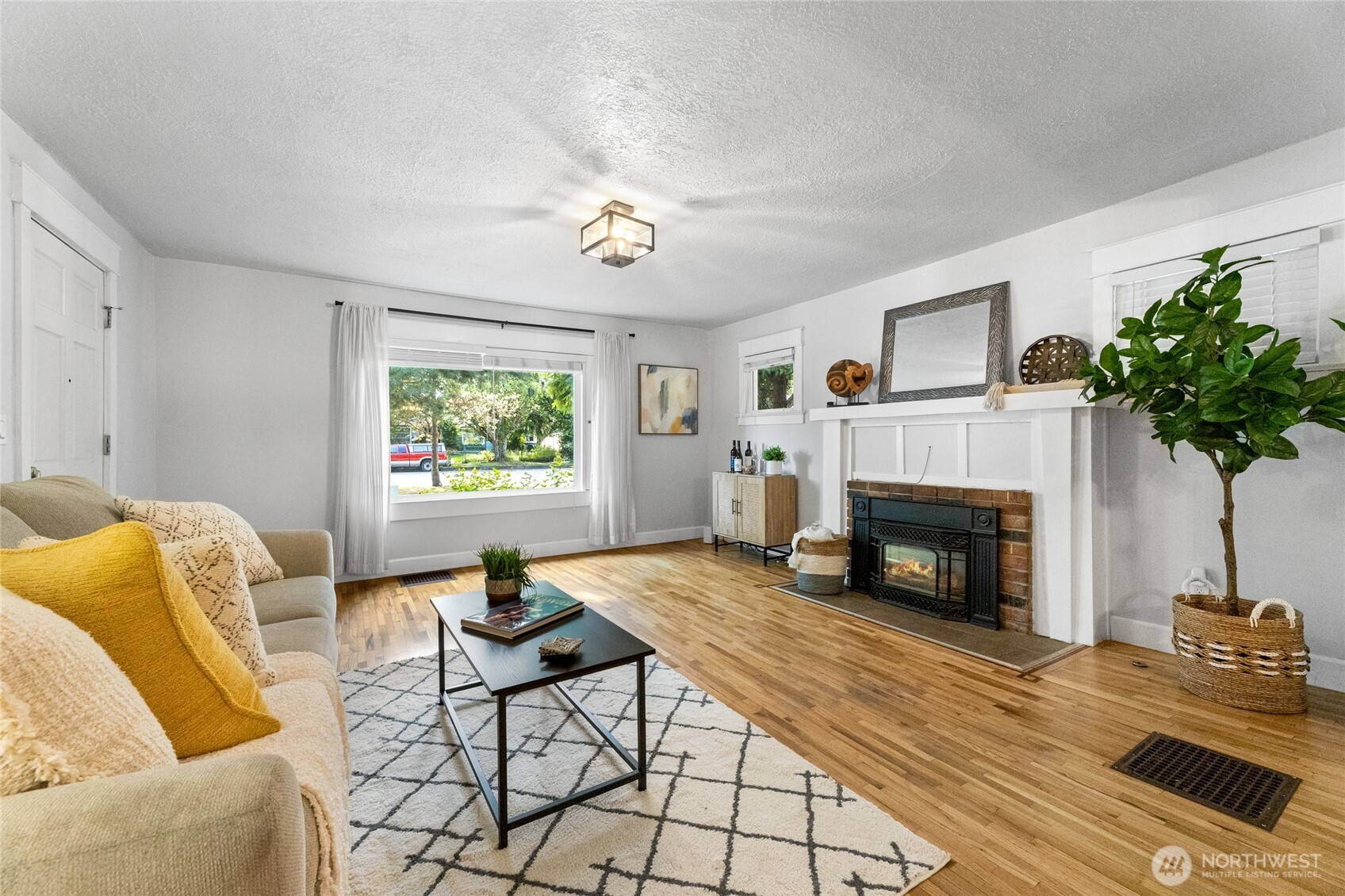 Bright living area with gas fireplace & big picture window