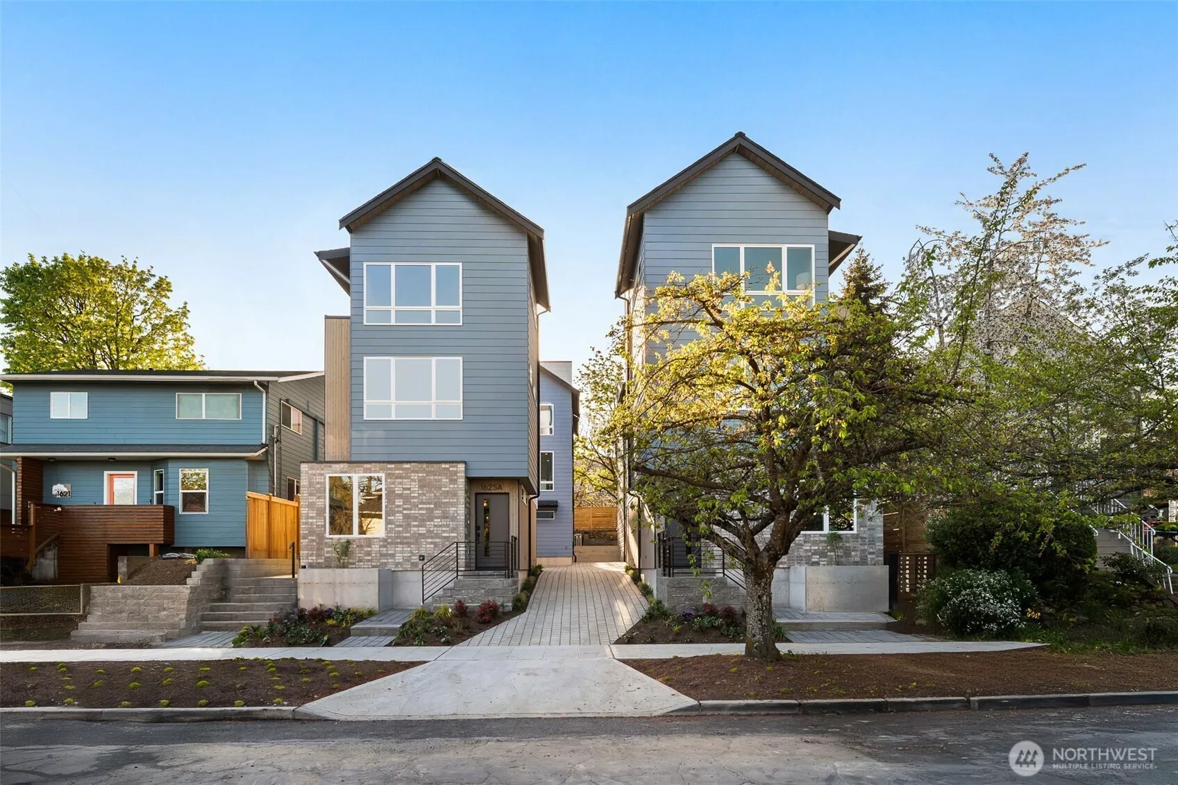 Welcome to the Capitol Pines Collection — where sleek modern design meets timeless Northwest charm. These striking homes make a statement from the curb with bold symmetry, crisp lines, and a central walkway that sets the tone for something unique.