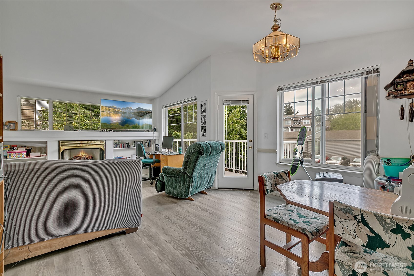 Spacious living room with cozy fireplace opens to your own private patio