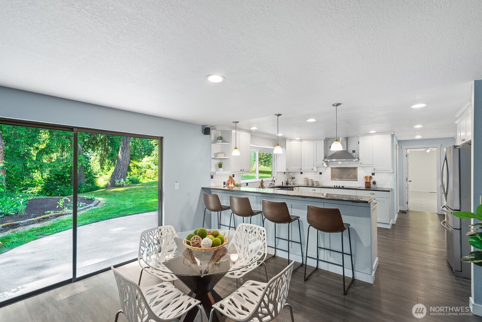 Casual dining area with sliding glass door to the beautiful back yard.