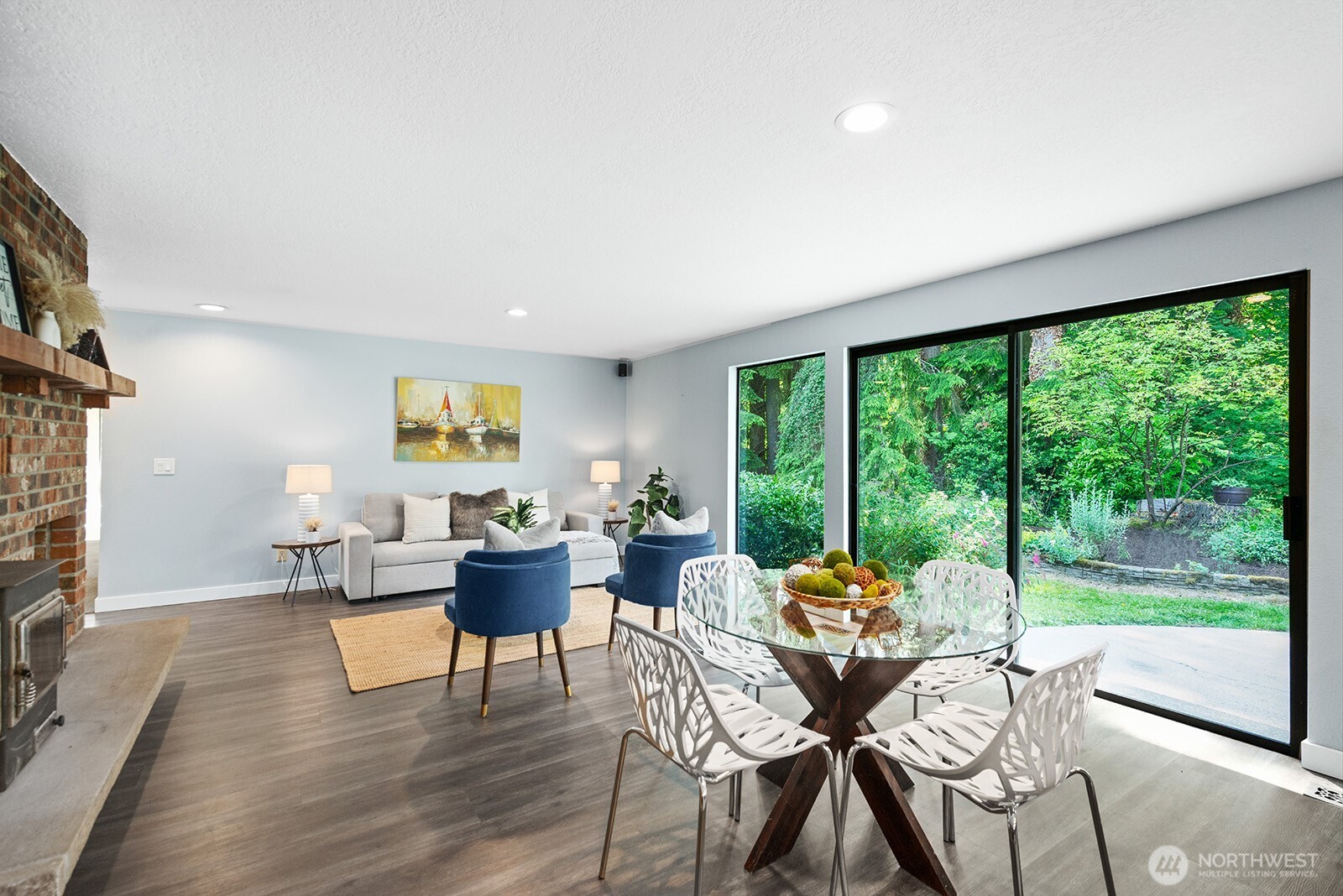 Casual dining area and family room with generous sliding glass door, bringing nature in...