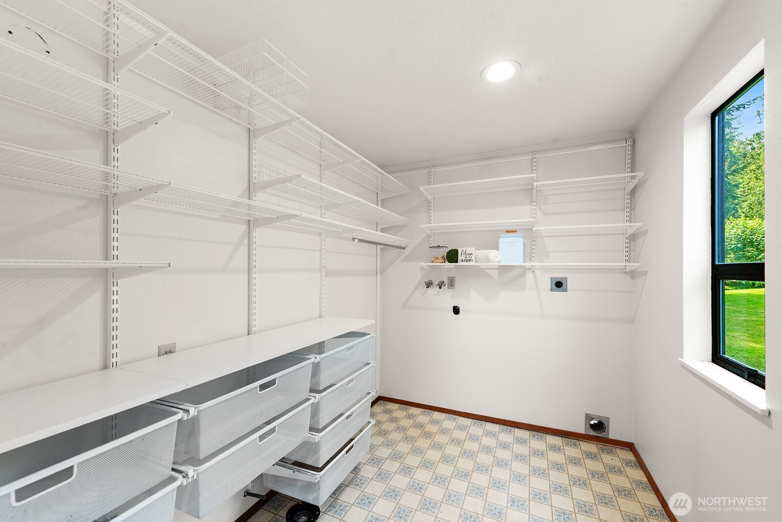 Pantry and laundry room designed with shelving & pull out storage.