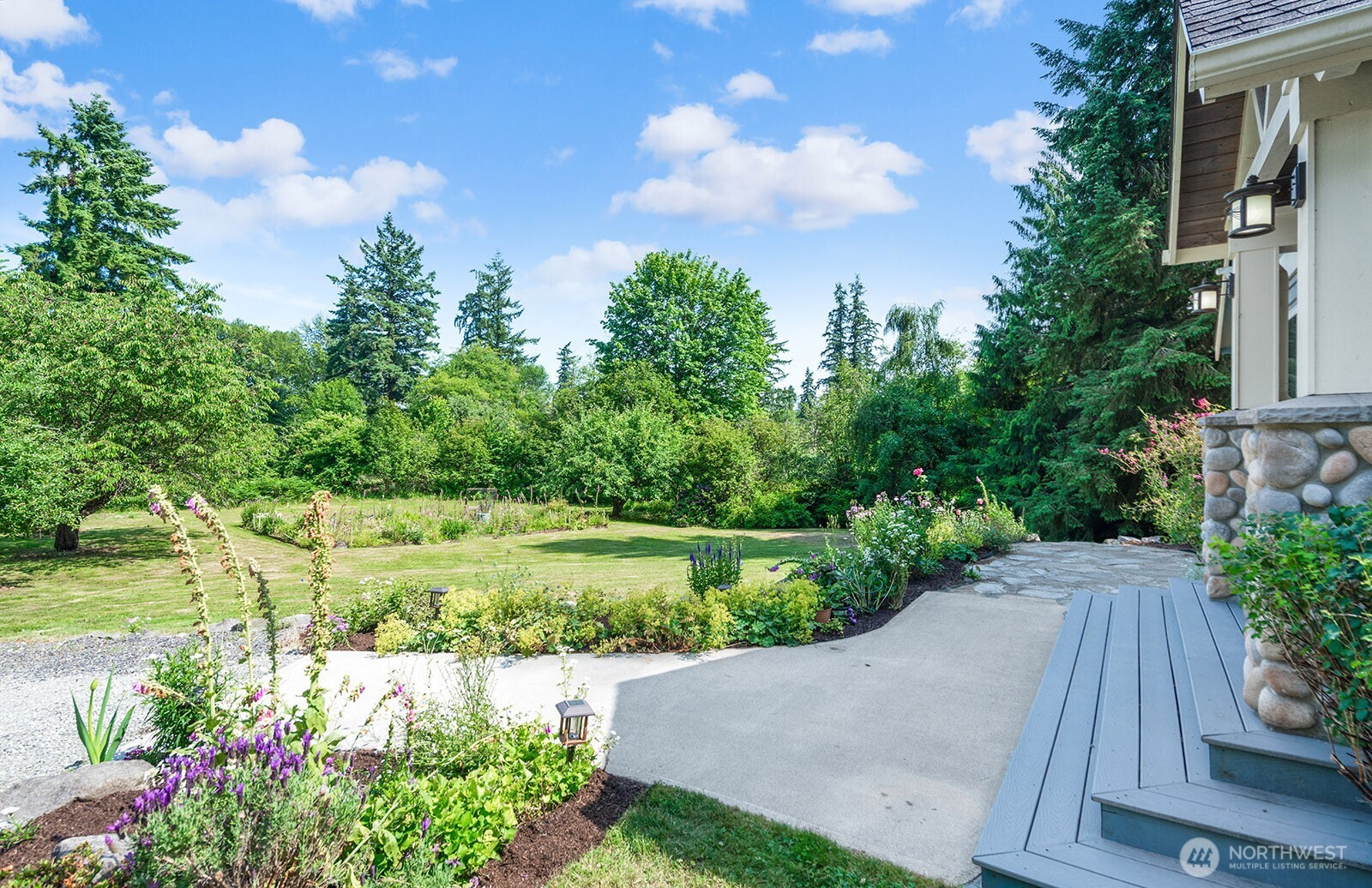 Front porch with with French doors to the Bonus room. Surrounded by beautiful new landscaping.