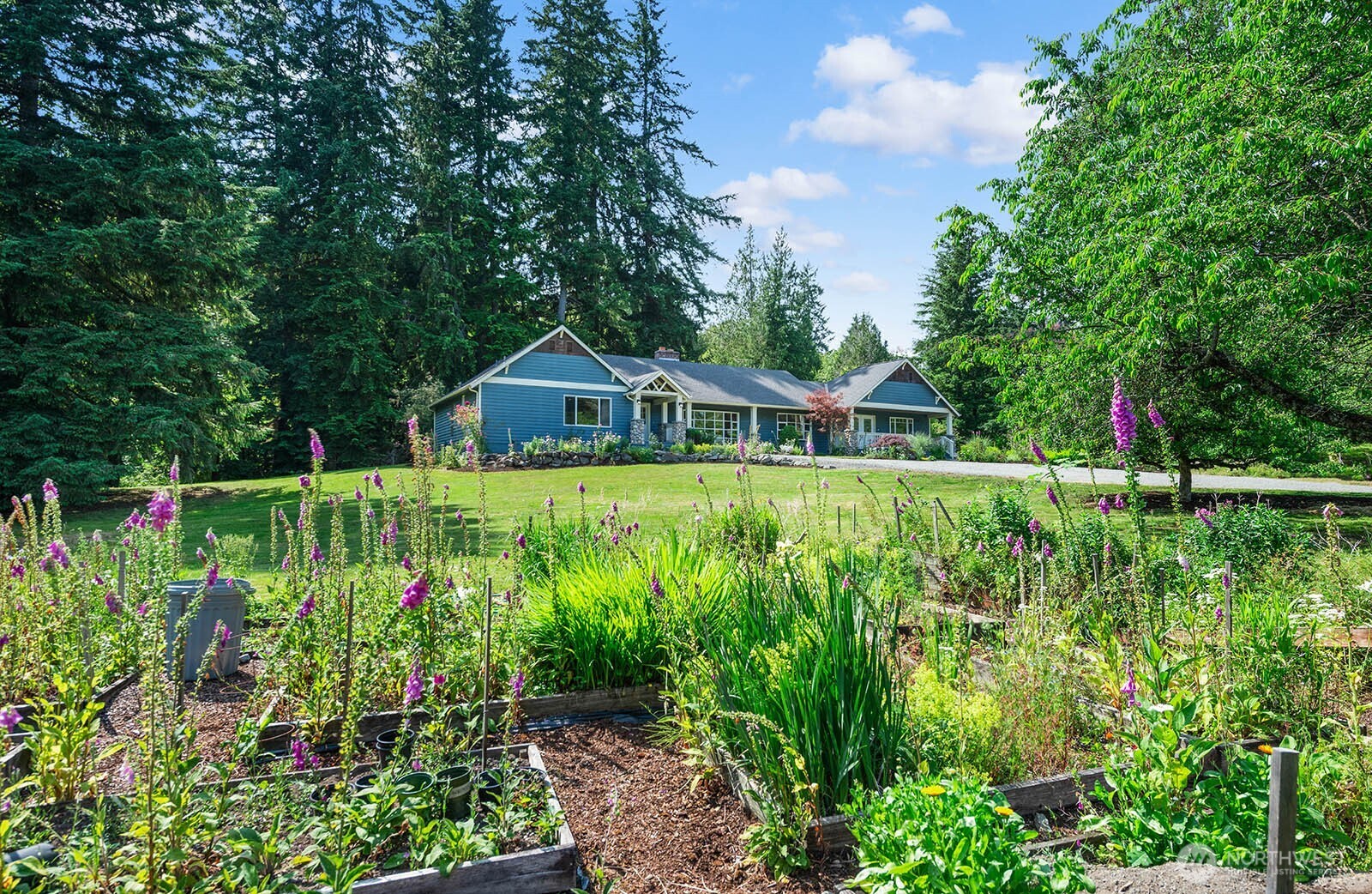 Impressive private acreage with generous lawn and new landscaping! Raised beds to grow your own garden.