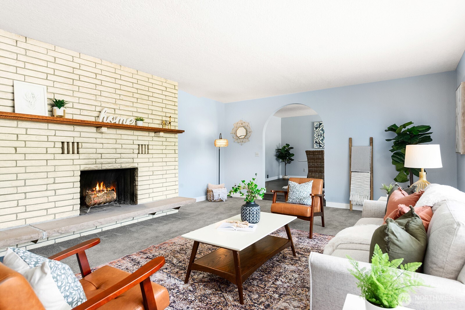 Formal living room with an arch entrance to formal dining room.