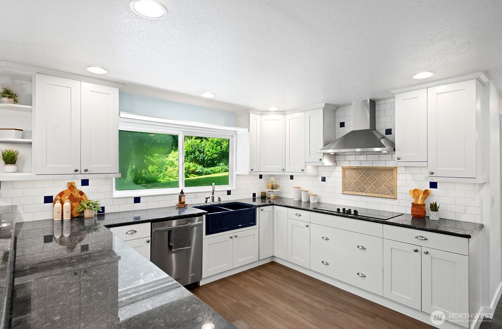 Custom kitchen includes Whitehaus double apron sink, striking granite countertops and custom tile backsplash