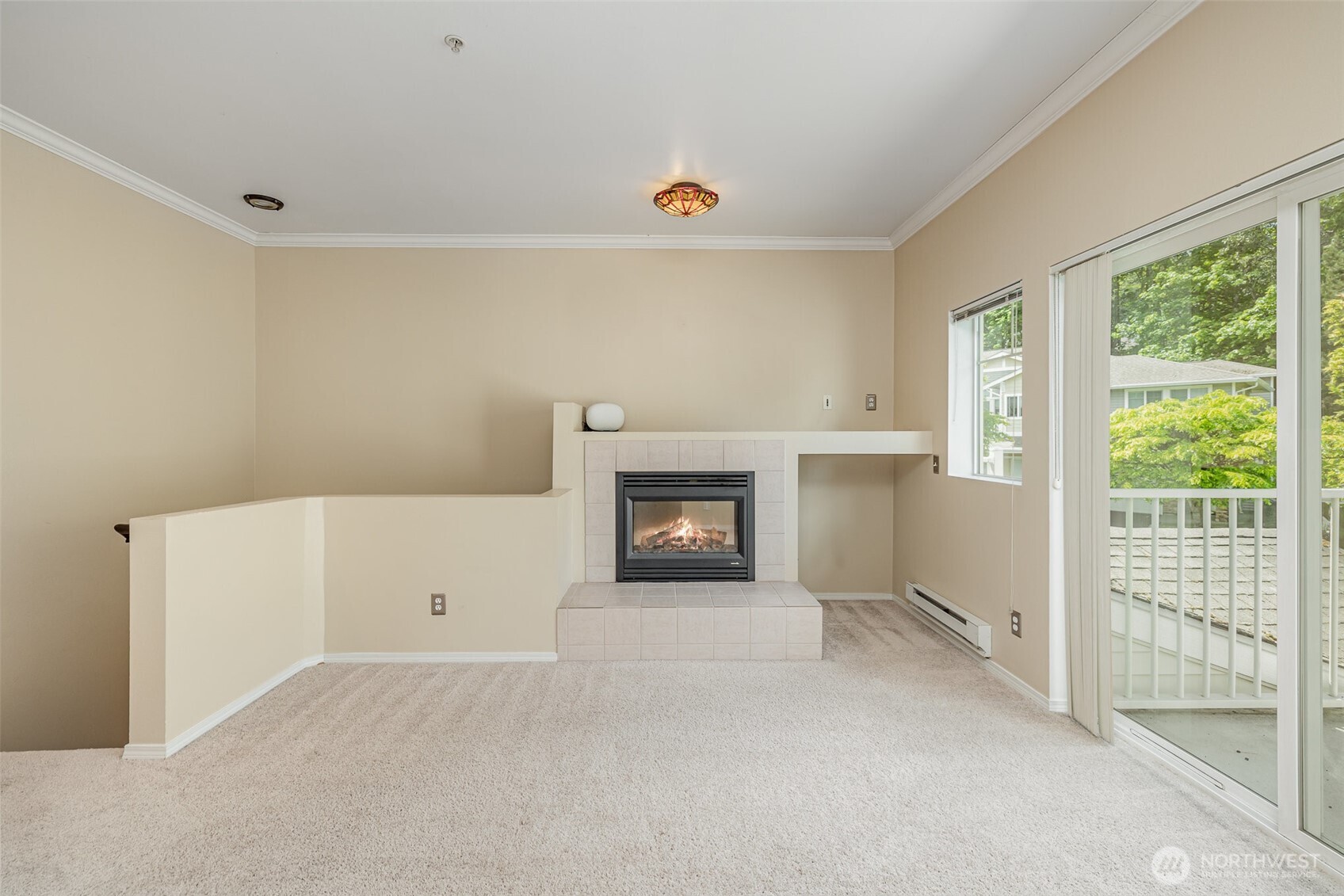 Living room with sliding glass doors that open up to a private balcony, bringing in fresh air and natural light.