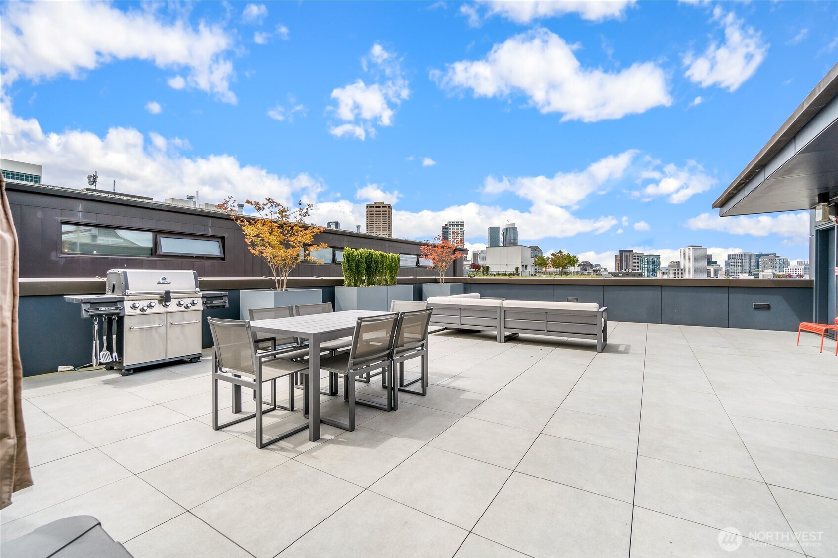 The well-appointed rooftop deck includes a seating area with fire feature, dining table, BBQ and views!