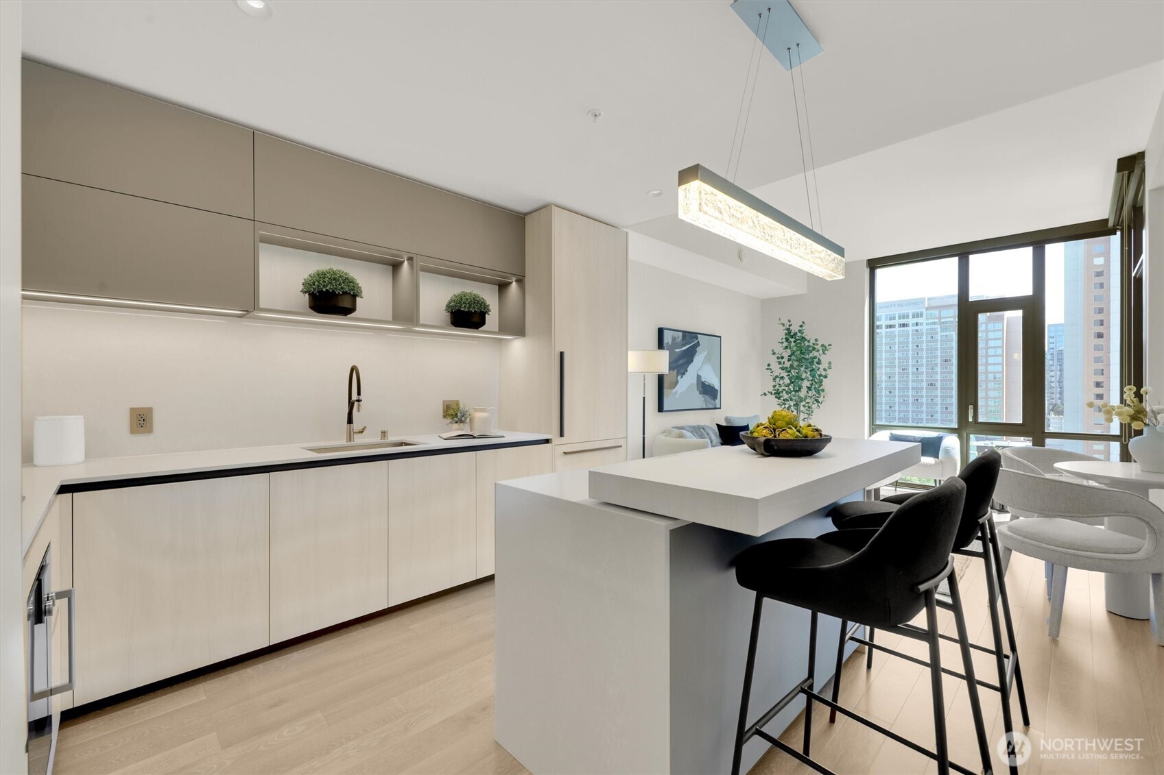 Beautiful Kitchen with 2 tier island counter and custom installed lighting above, built in fridge and cabinets