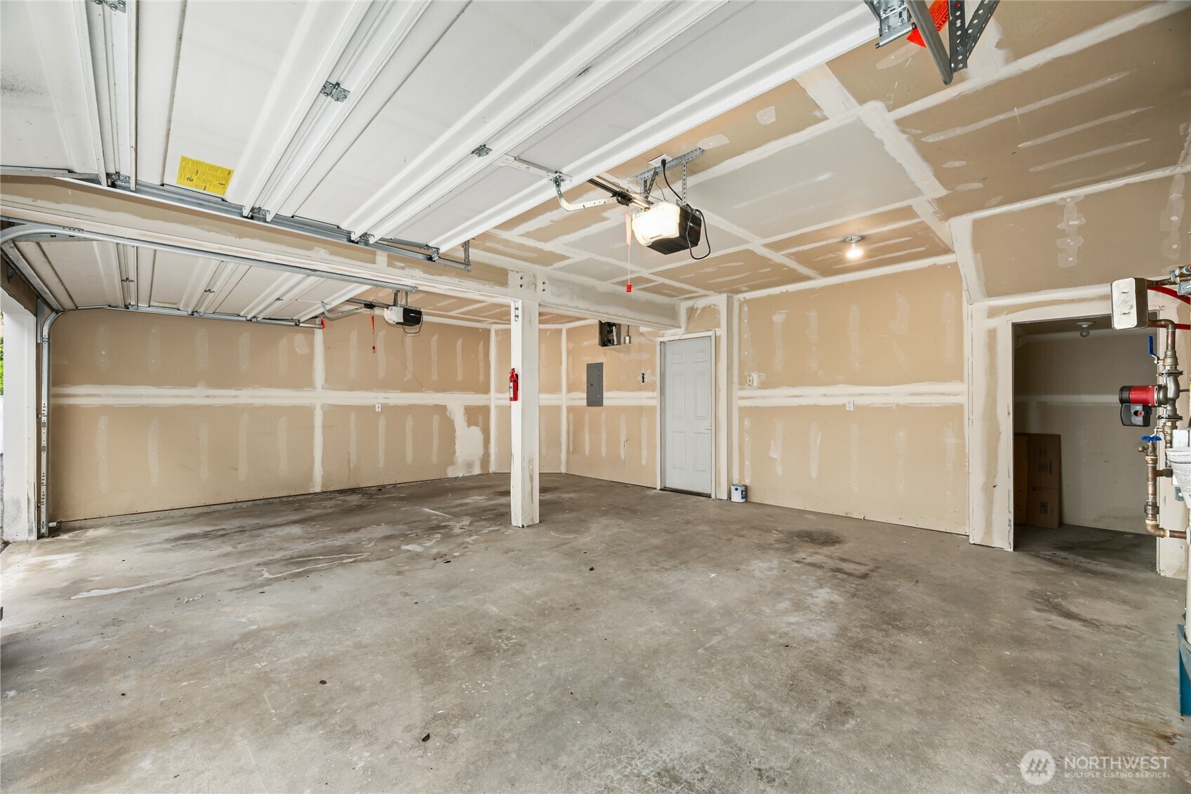 Gigantic 2 car garage with an extra storage area to the right. It is rare to find a garage this spacious with this much storage!
