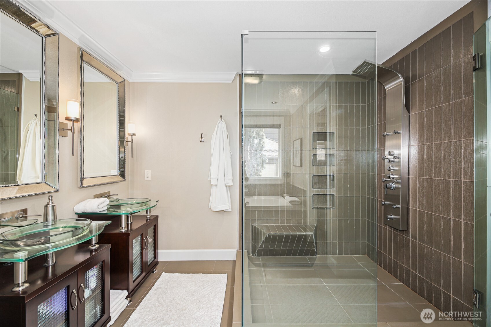 Individual sinks and a bench in the custom shower.