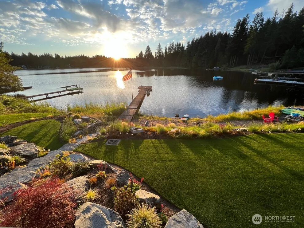 Unobstructed lake views, an expansive terraced back yard, a sandy beach and a private dock await you!