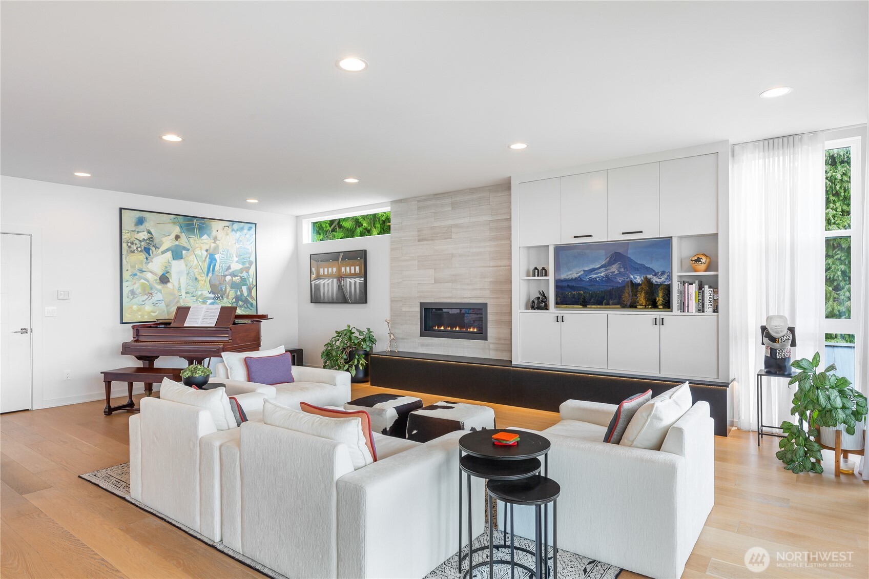 Living room with custom built-ins and fireplace with stone facade.