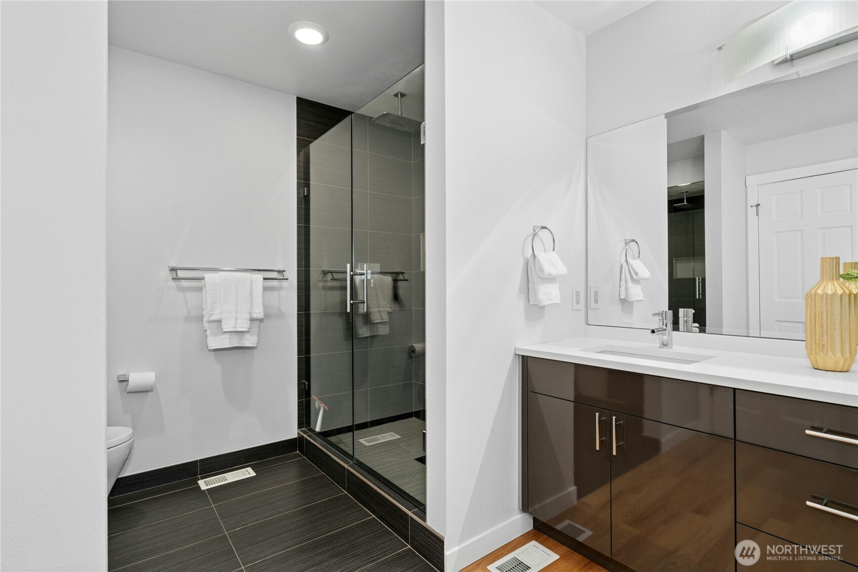 Walk in shower with elegant glass door.