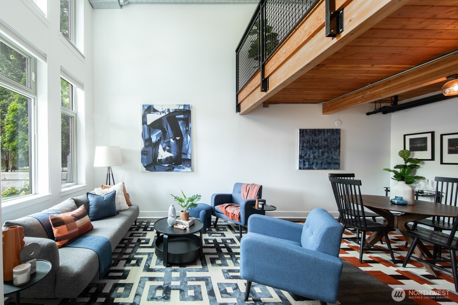 Soaring ceilings and exposed wood beams create a warm, open feel.
