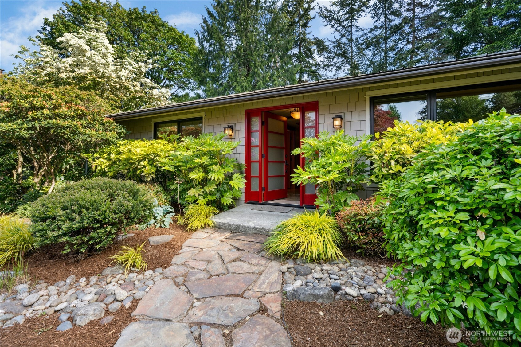 Beautiful stone walkways approach this charming rambler.