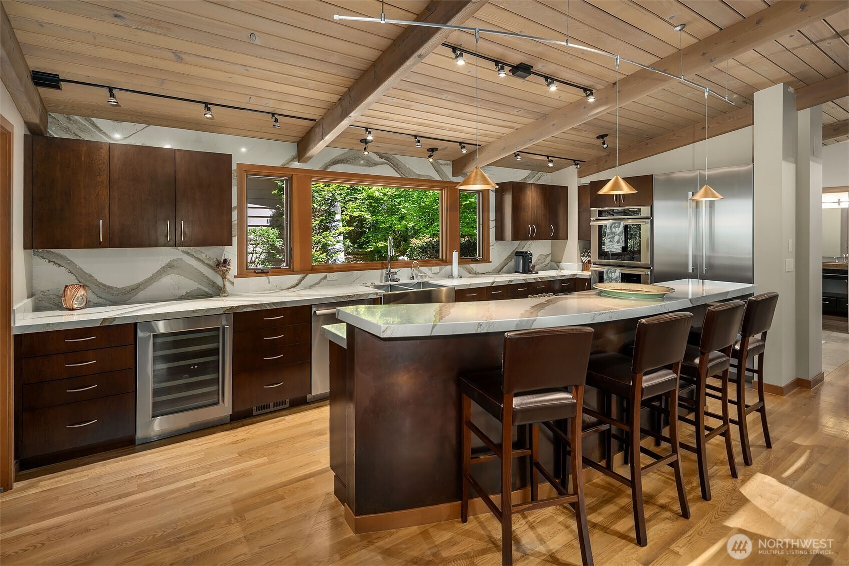 Updated quartz kitchen with walk-in pantry, raised breakfast bar and high end Thermador appliances