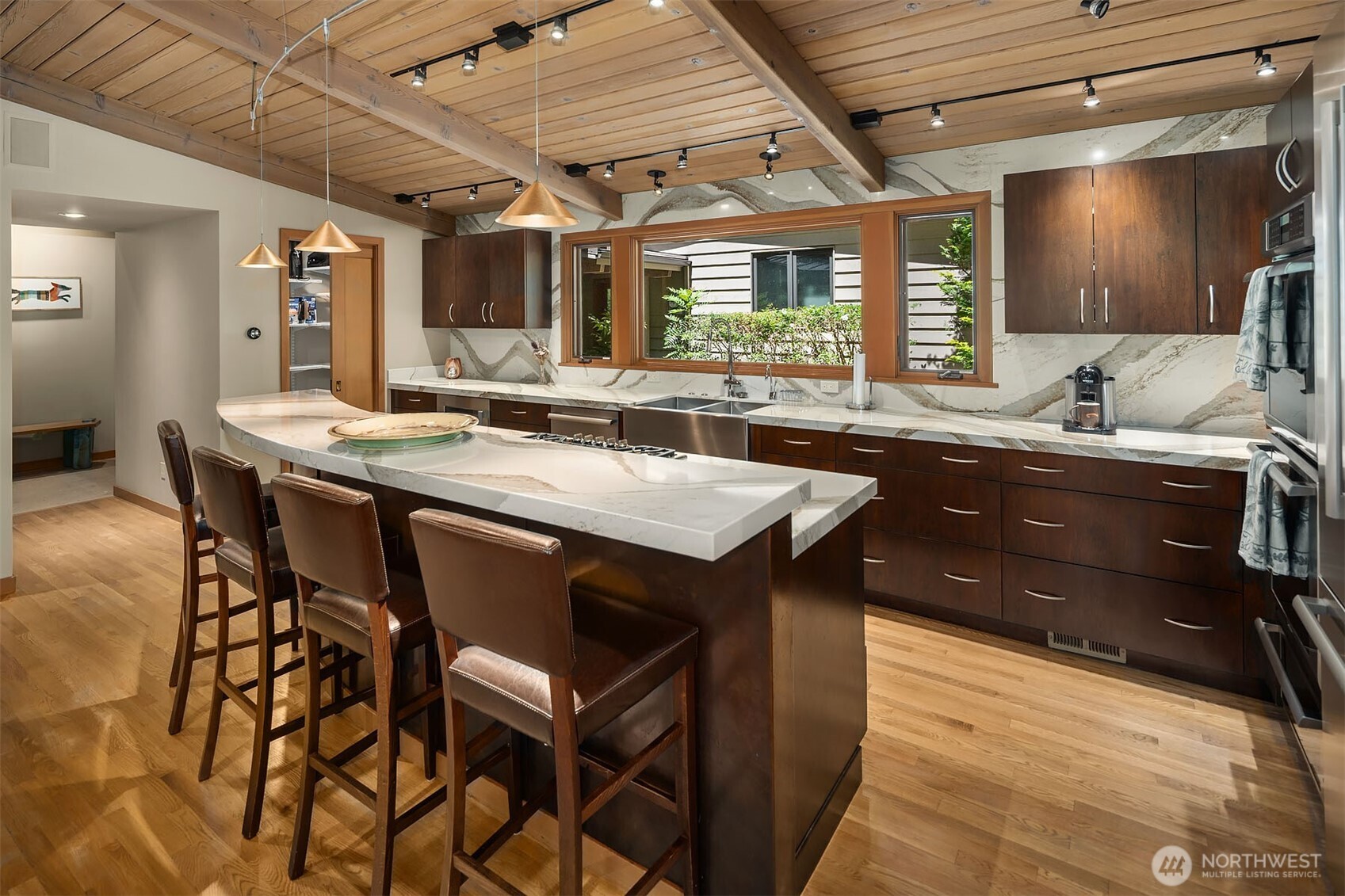 Updated quartz kitchen with walk-in pantry, raised breakfast bar and high end Thermador appliances