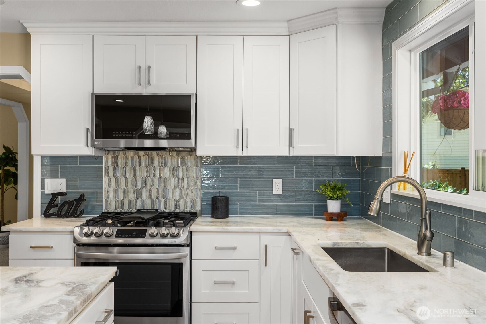 Stylish backsplash and gas range in this gorgeous kitchen.