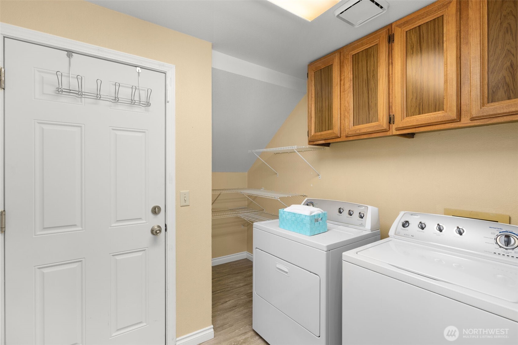 Large laundry room has additional storage.