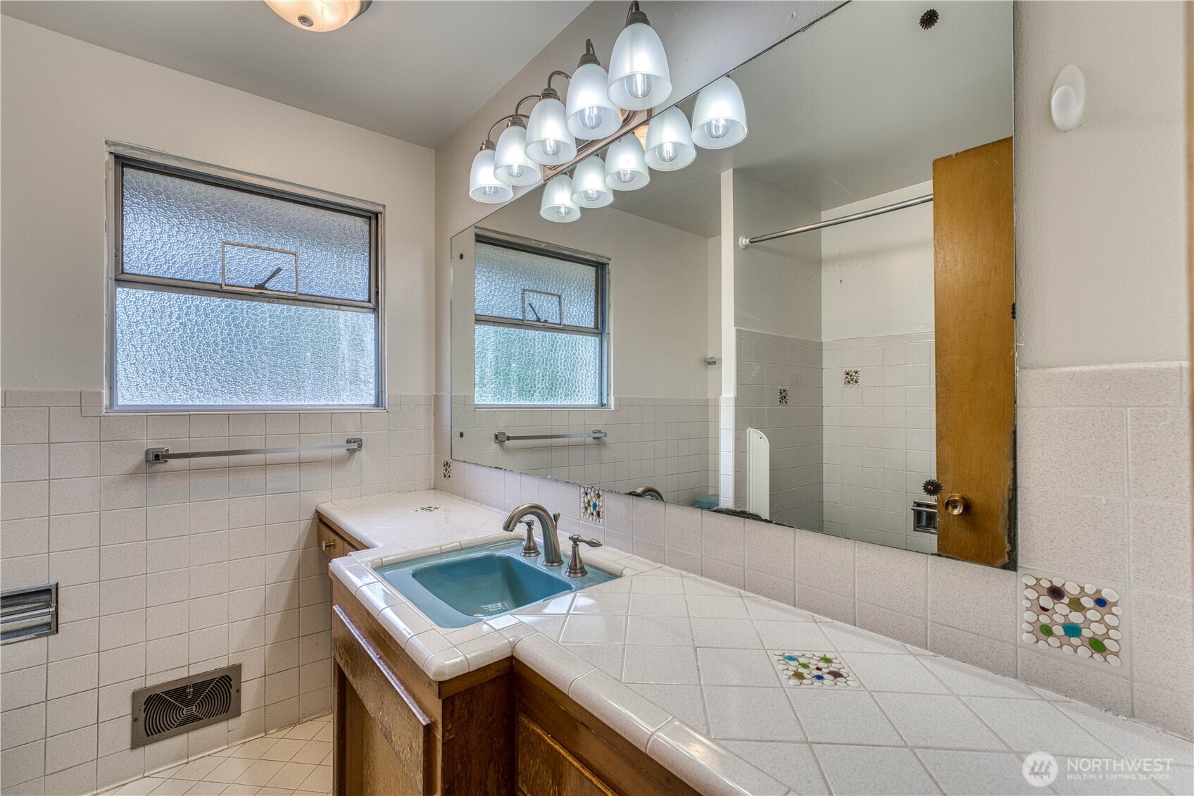 Beautiful tile work in the full bath located on the main floor.