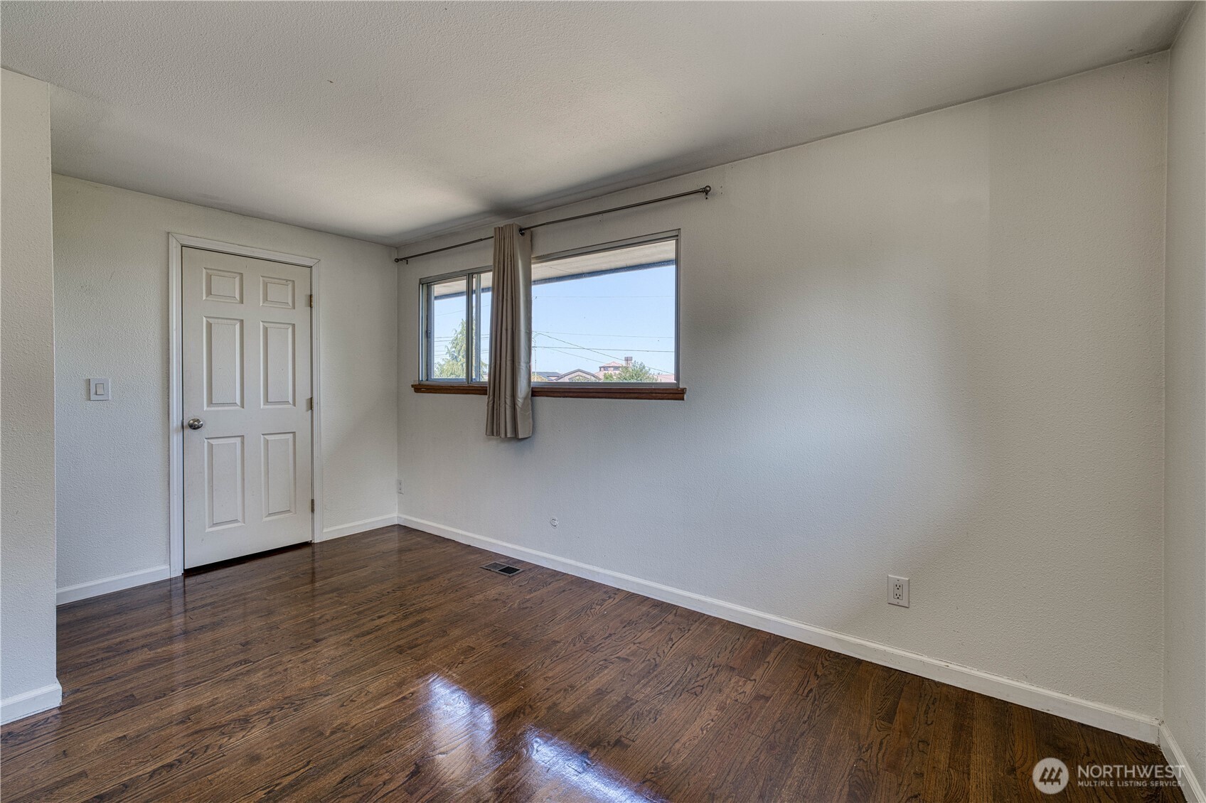 This view in the primary bedroom shows the door to the walk-in closet