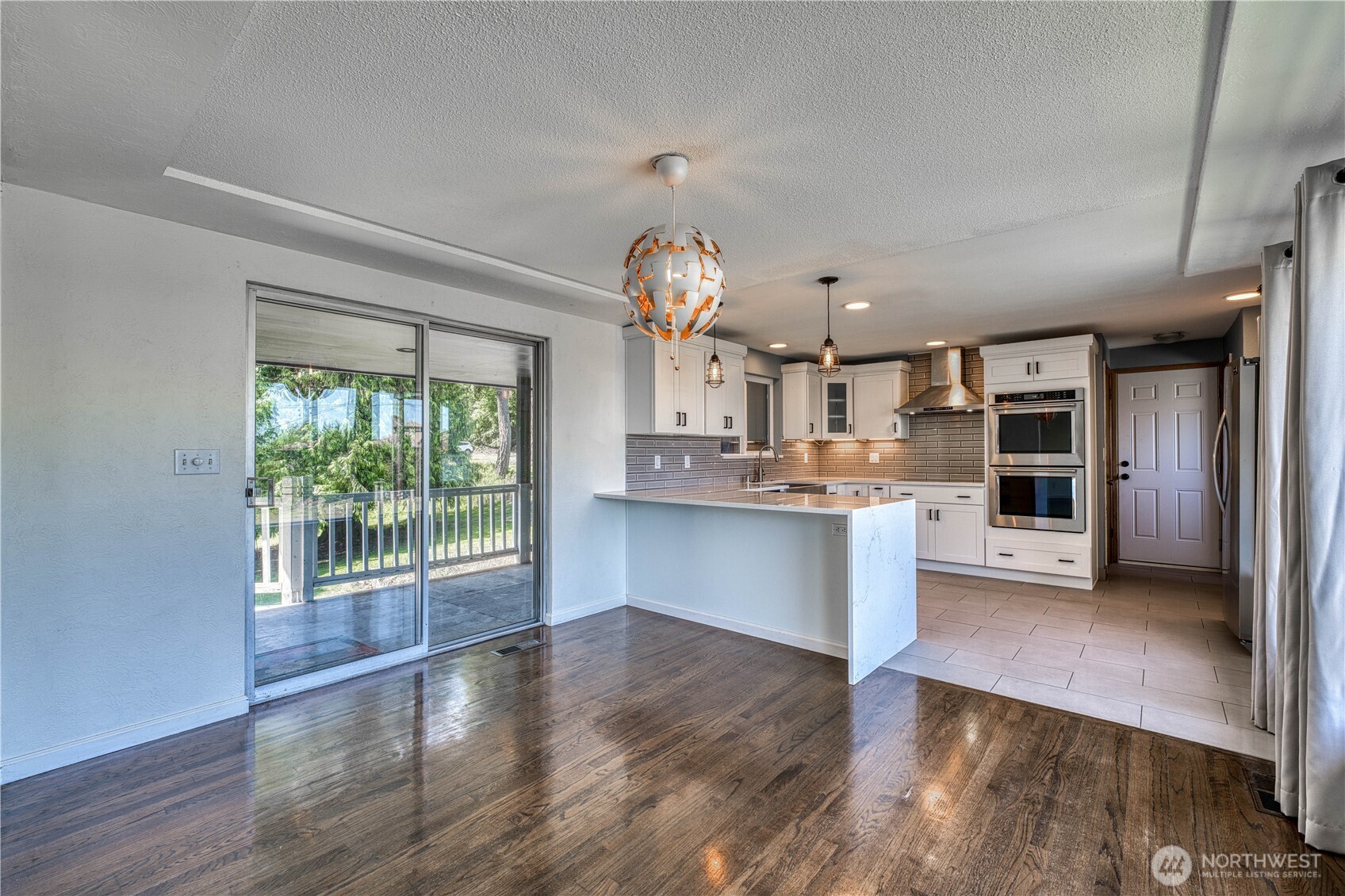 Standing in the livingroom looking to the dining nook and awesome kitchen