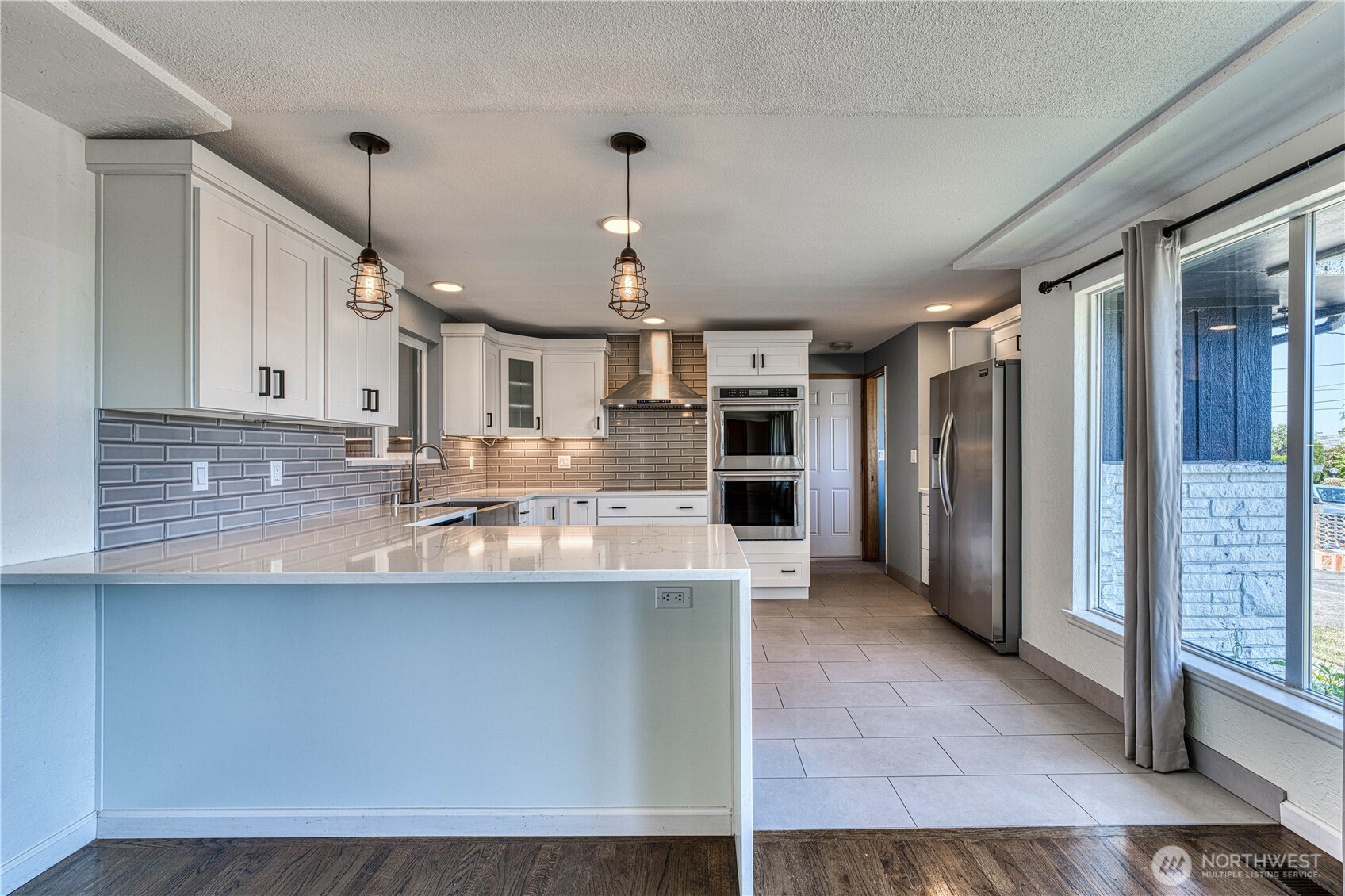 This is a GREAT isolated picture of the modernized and updated kitchen. Sparkling hard surfaces, stainless appliances and lots of bright white cabinetry