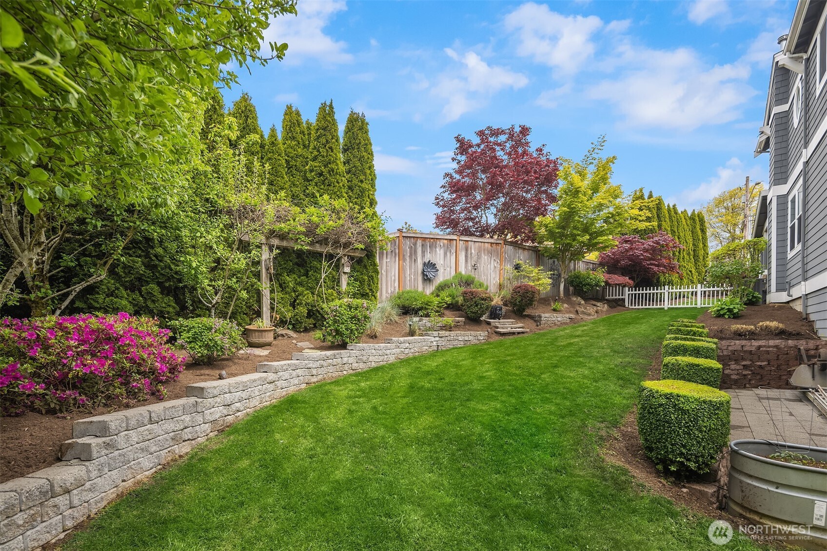 Equally as important as the back yard, this home's side yards, with their mature vegetation, provide room to play and ideal privacy from neighbors.