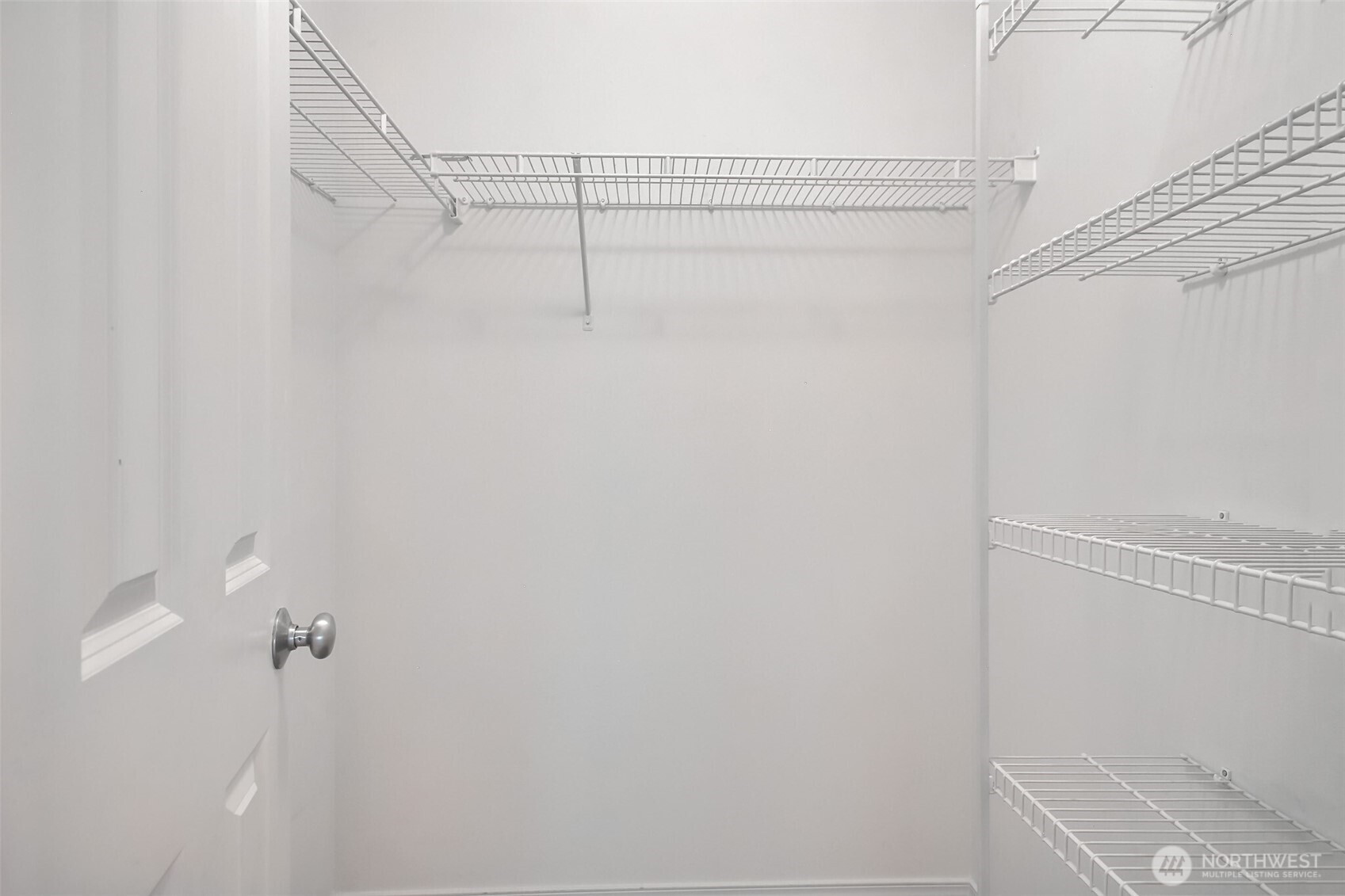 Walk in closet with custom shelves.