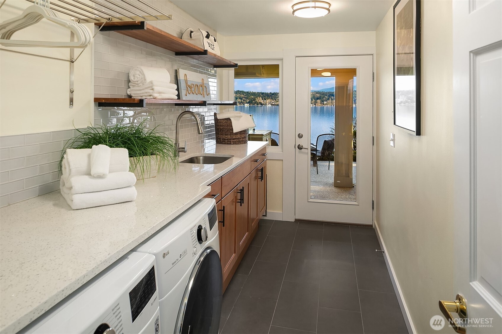 Huge laundry room with loads of storage and access to outside.