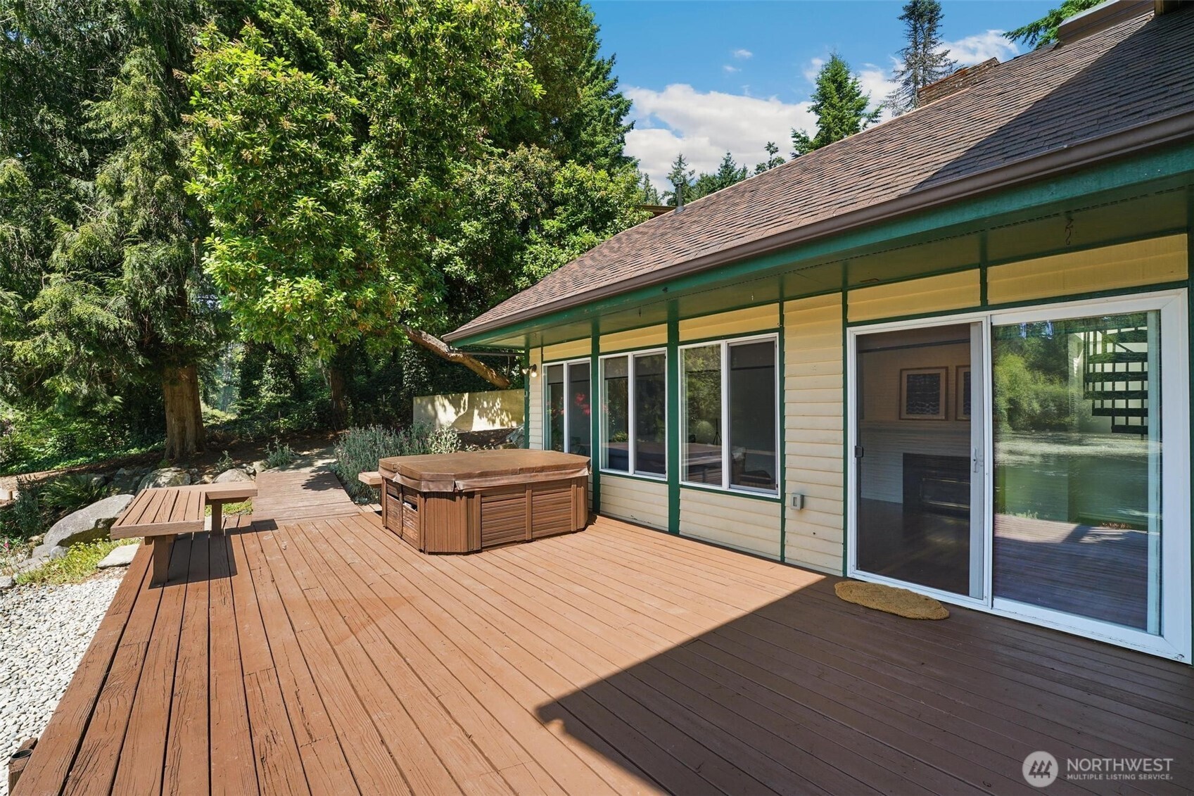 on the deck you will find seating, the hot tub, and the sliding door entry to the main living area.