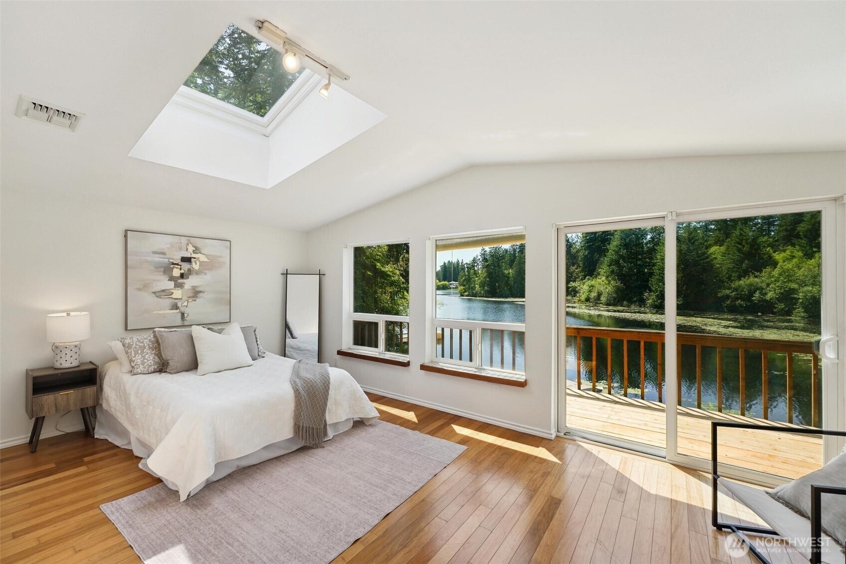 Spacious bedroom with vaulted ceiling and skylight