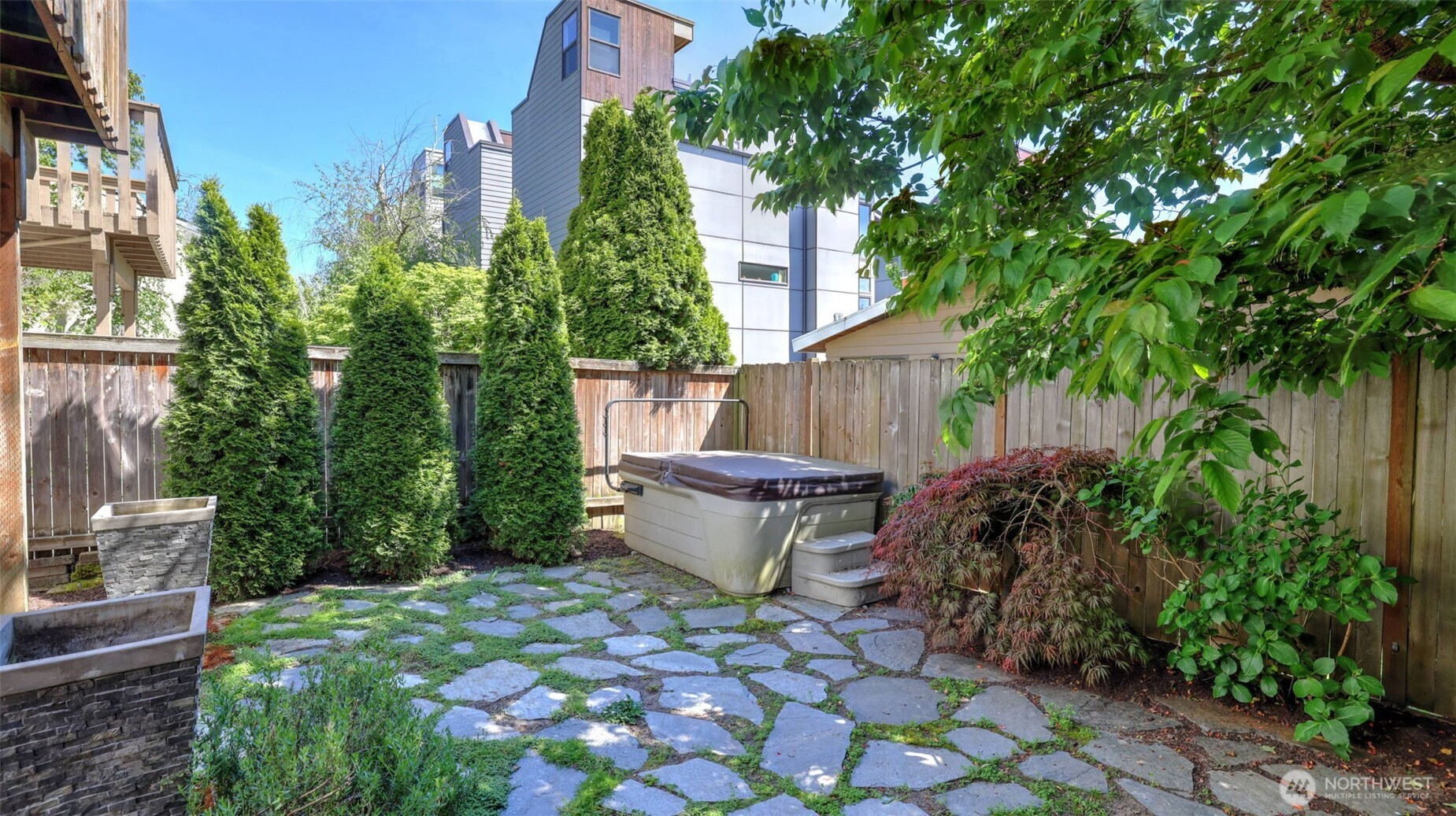 Fully fenced backyard with hot tub, patio, garden space and storage shed